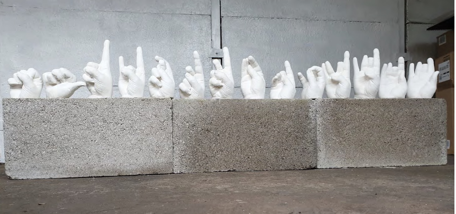 plaster cast hands on breeze blocks